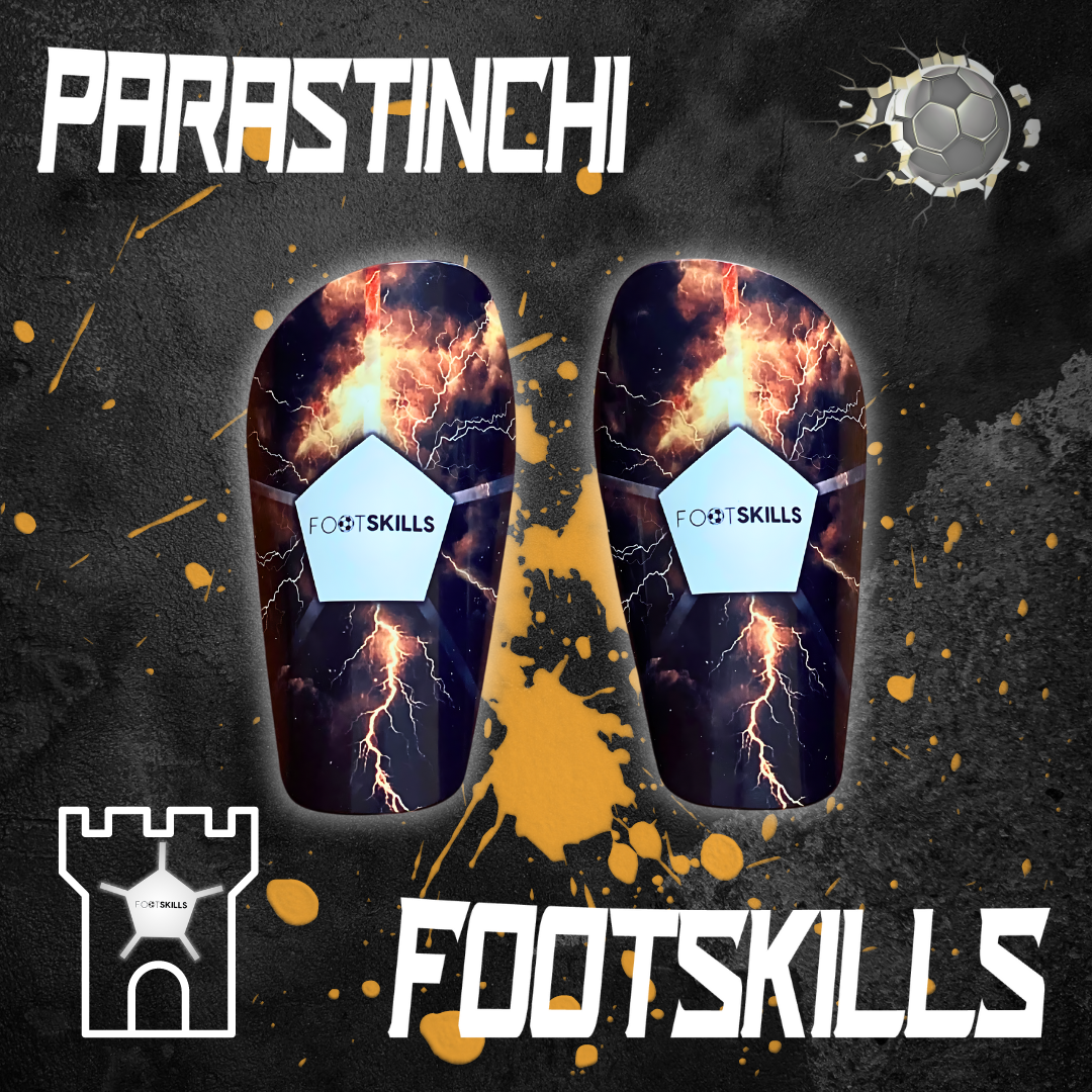 Parastinchi Footskills con un vivace design di fulmini e fuoco, rappresentando energia e forza. Il design audace è pensato per calciatori che cercano protezione con un tocco di stile aggressivo nel gioco.
