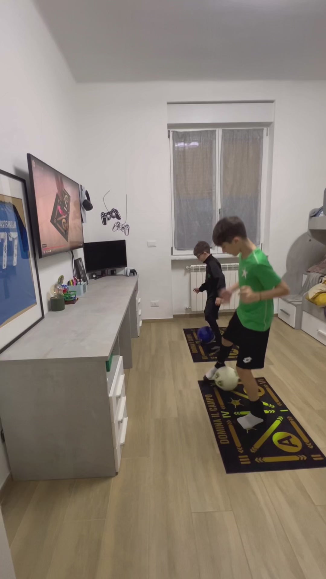 Two players training side by side on soccer mats in a bedroom setup, practicing agility and coordination.